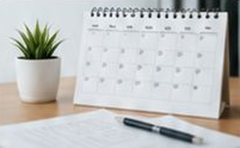 Desk calendar with a plant and lease documents